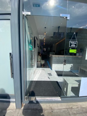 Facing entrance straight ahead. Handle on left, push to open.