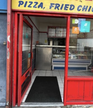 Glass door with red frame ahead. Push from right to open.