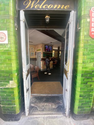 Facing entrance. Pull doors from middle to open.