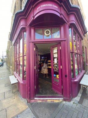 Pink framed glass doors. Push silver handle in center to open.