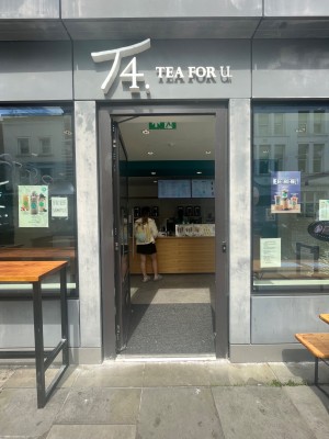 Glass door with black frame. Push silver, metal handle on right to open.