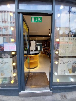 Entrance to centre of venue from street, manual door push open from right.