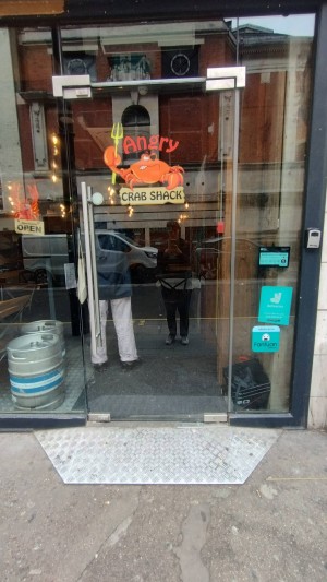 Glass door with silver handle on left. Pull to open.