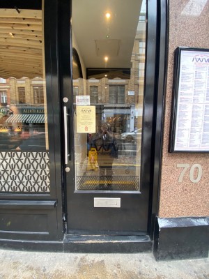 Push glass door with handle on the left.