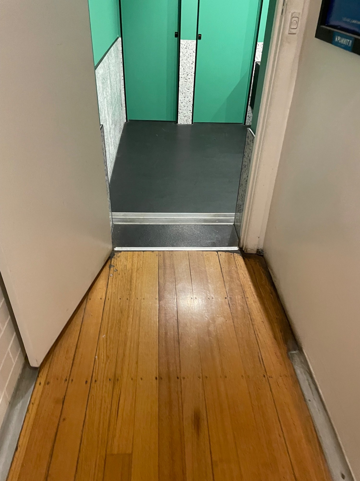 End of hallway and 2 steps down to bathroom