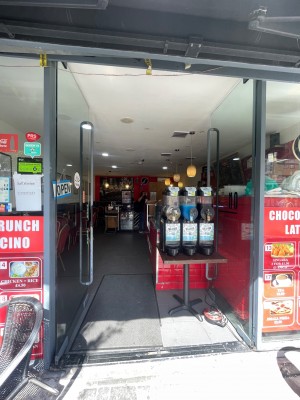 Glass doors with black frame. Black handles in middle, push to open.