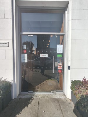 Glass door. Push silver handle on right to open.