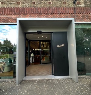 Glass door with black frame ahead. Doors slides to open.