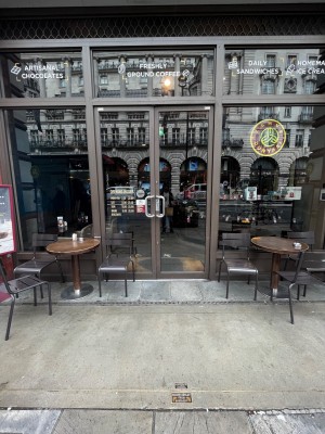 Doors from street. Push double doors from middle to open. Chair slightly obstructing doors on left. Small bump at foot of door.