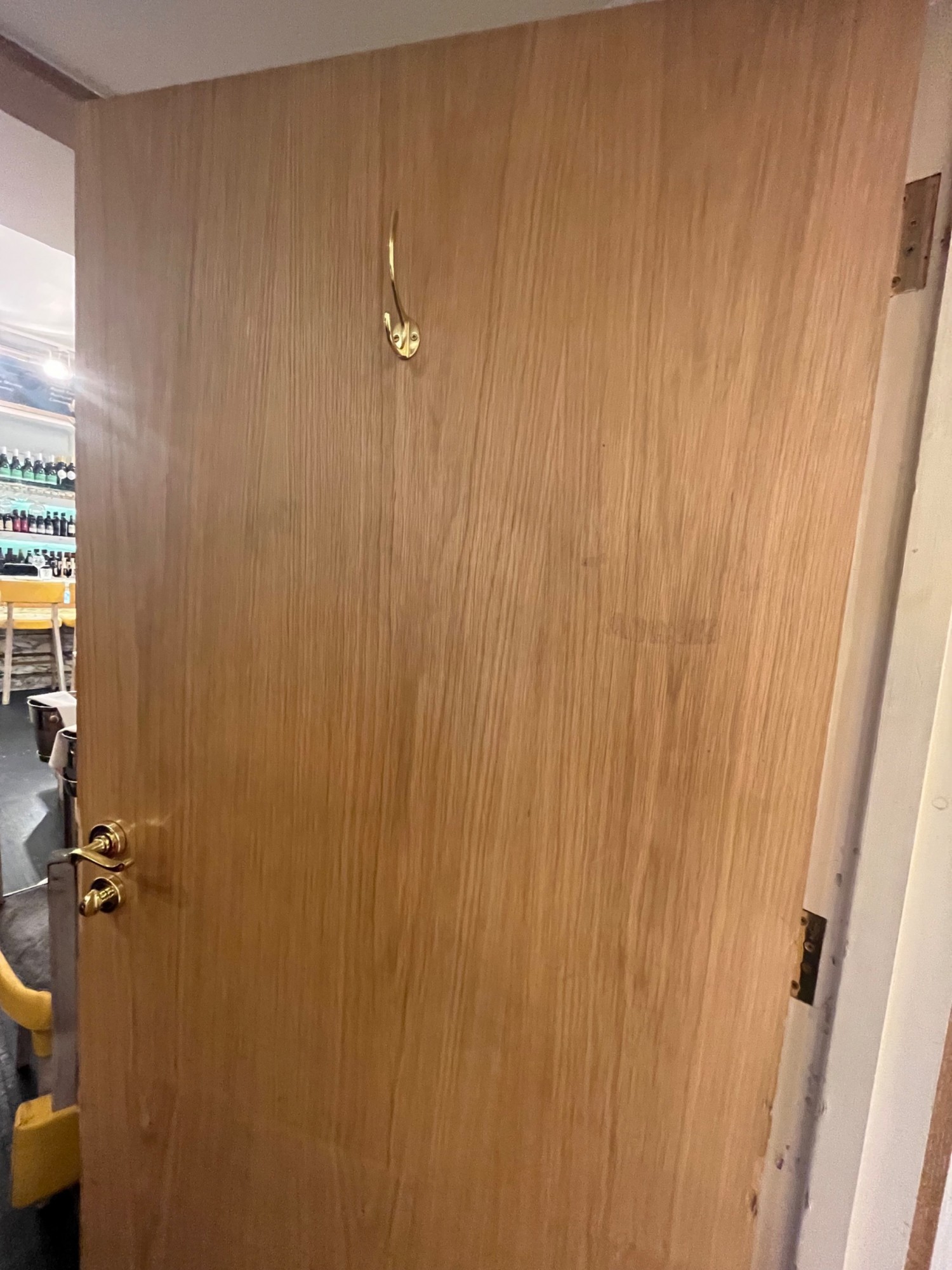 Back of bathroom door. High hanging hook in middle. Turn lock on left.
