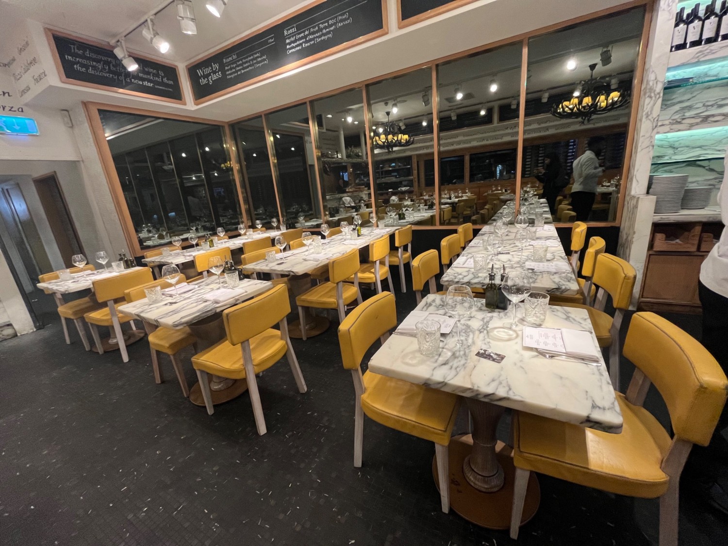 From path facing slightly right. Tables and chairs on the left middle and right.