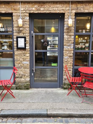 Single glass door with handle on the left. Pull door
