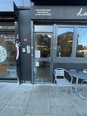Metal-framed glass door ahead. Push from handle on right to open.
