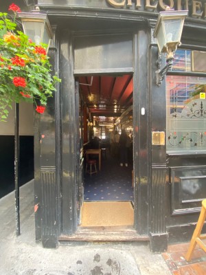Glass door with black frames ahead. Push to right to open.