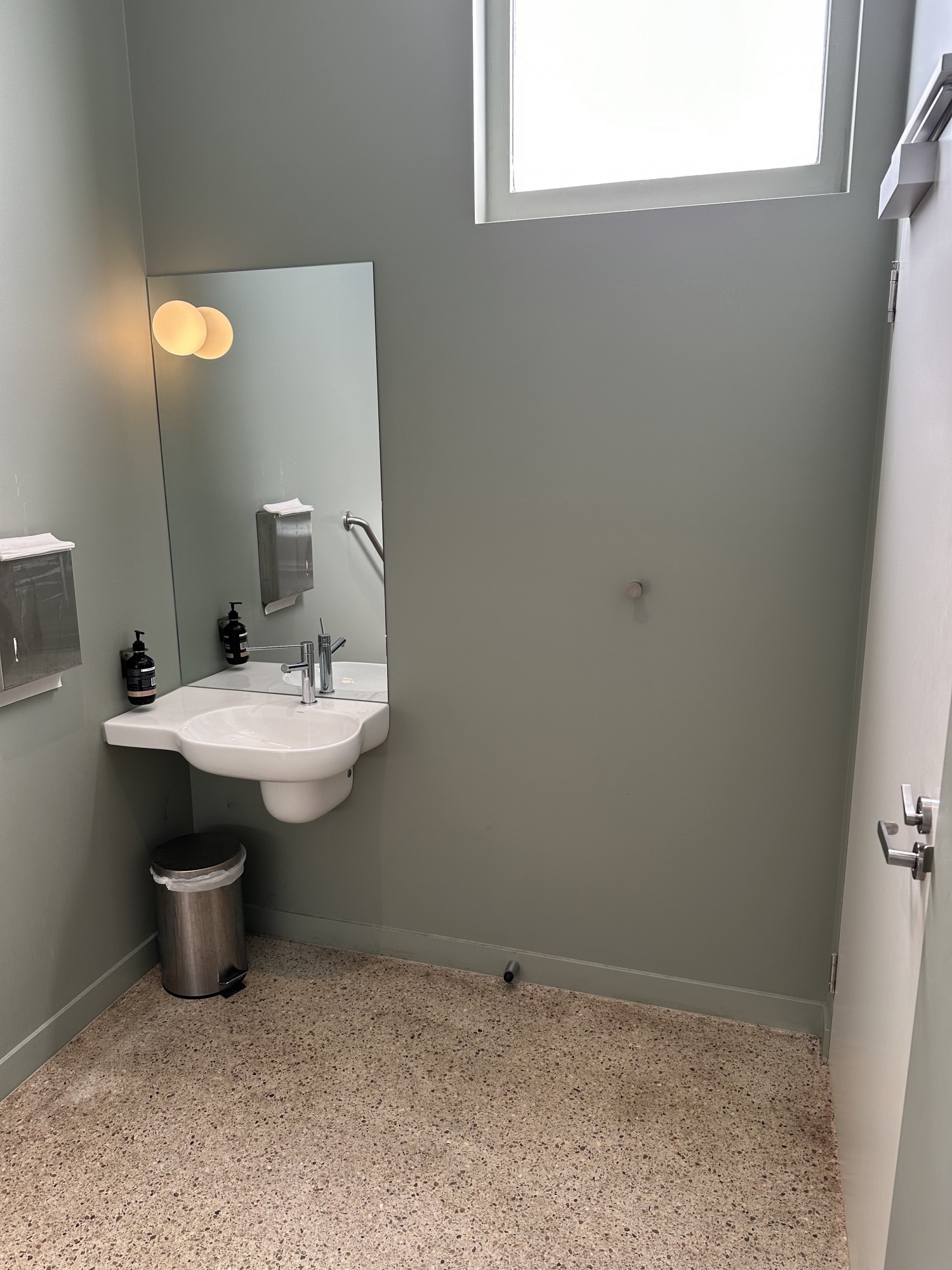 Image of basin and mirror set against wall.