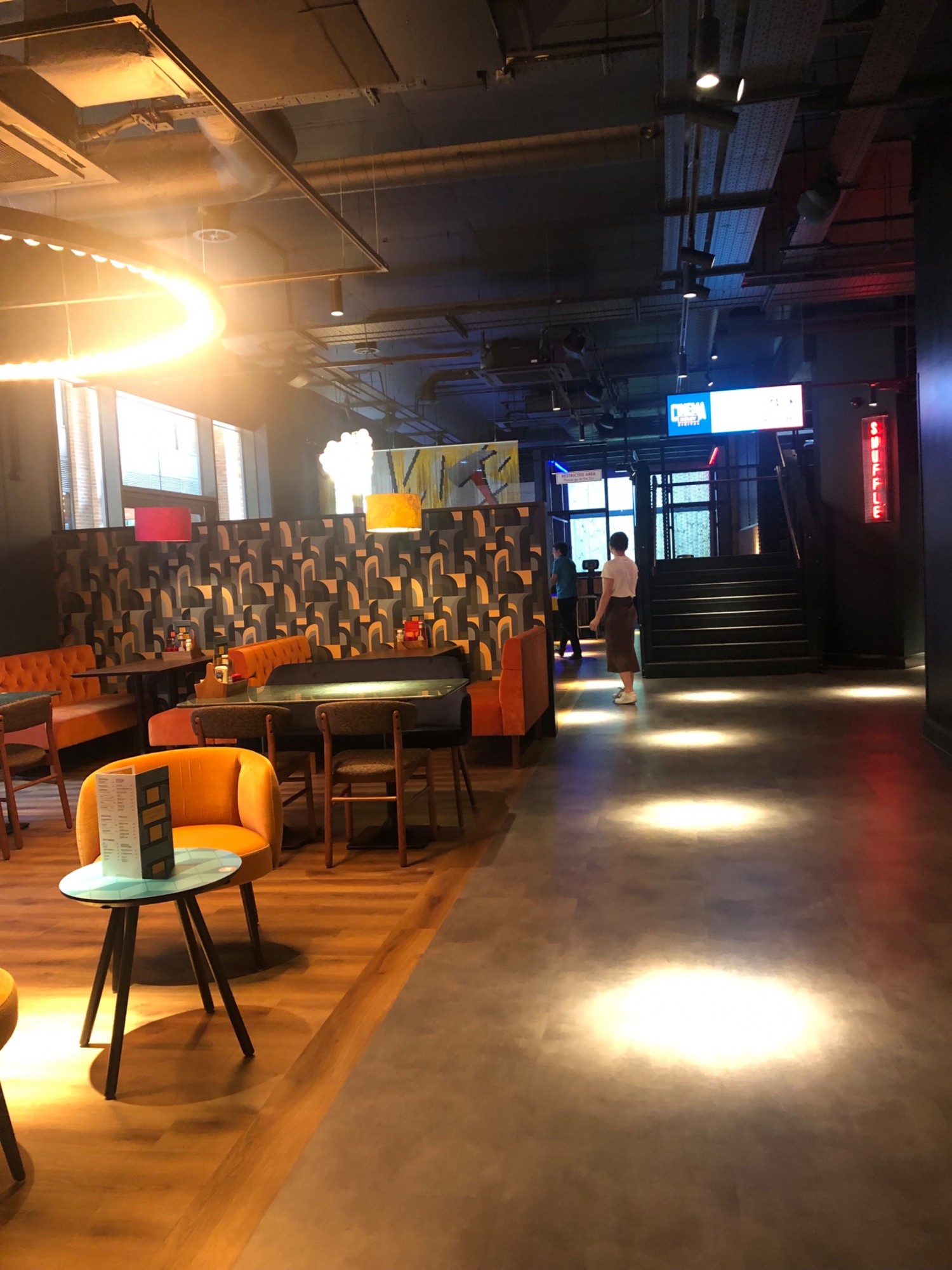 Mixed seating of chairs and booths in eating area off main foyer and bar.