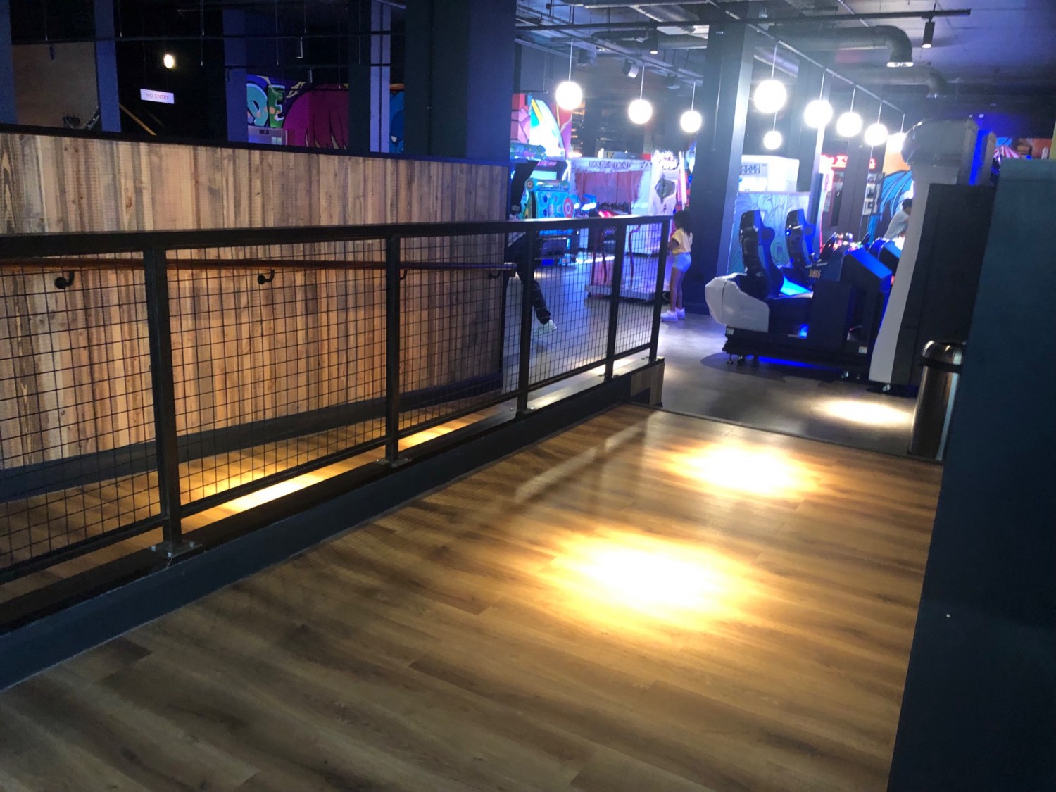 Wooden flooring, long ramp and steps from blowing area looking down towards arcade area.