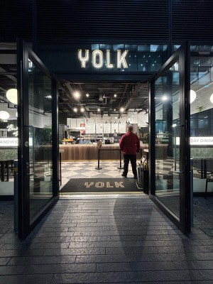 Glass doors with black frame ahead. Pull silver handles in centre to open.