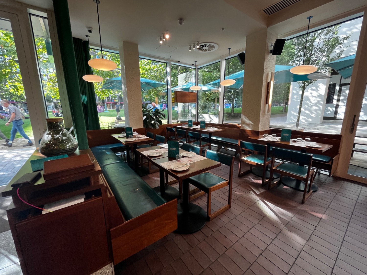Left side main area seating. Half booths on left, right, and back walls.