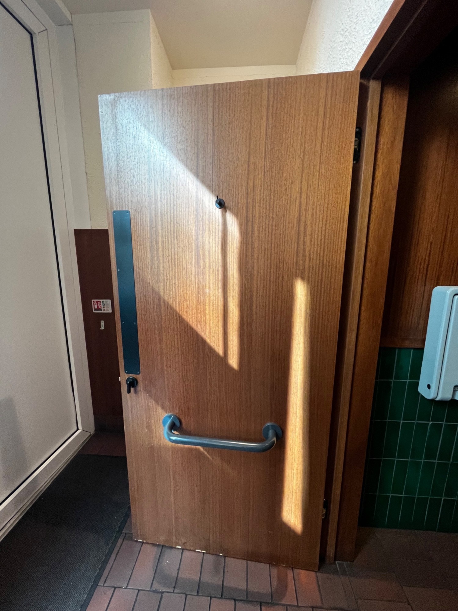Back of bathroom door. High hanging hook in middle. Grab rail in middle. Turn lock on left.