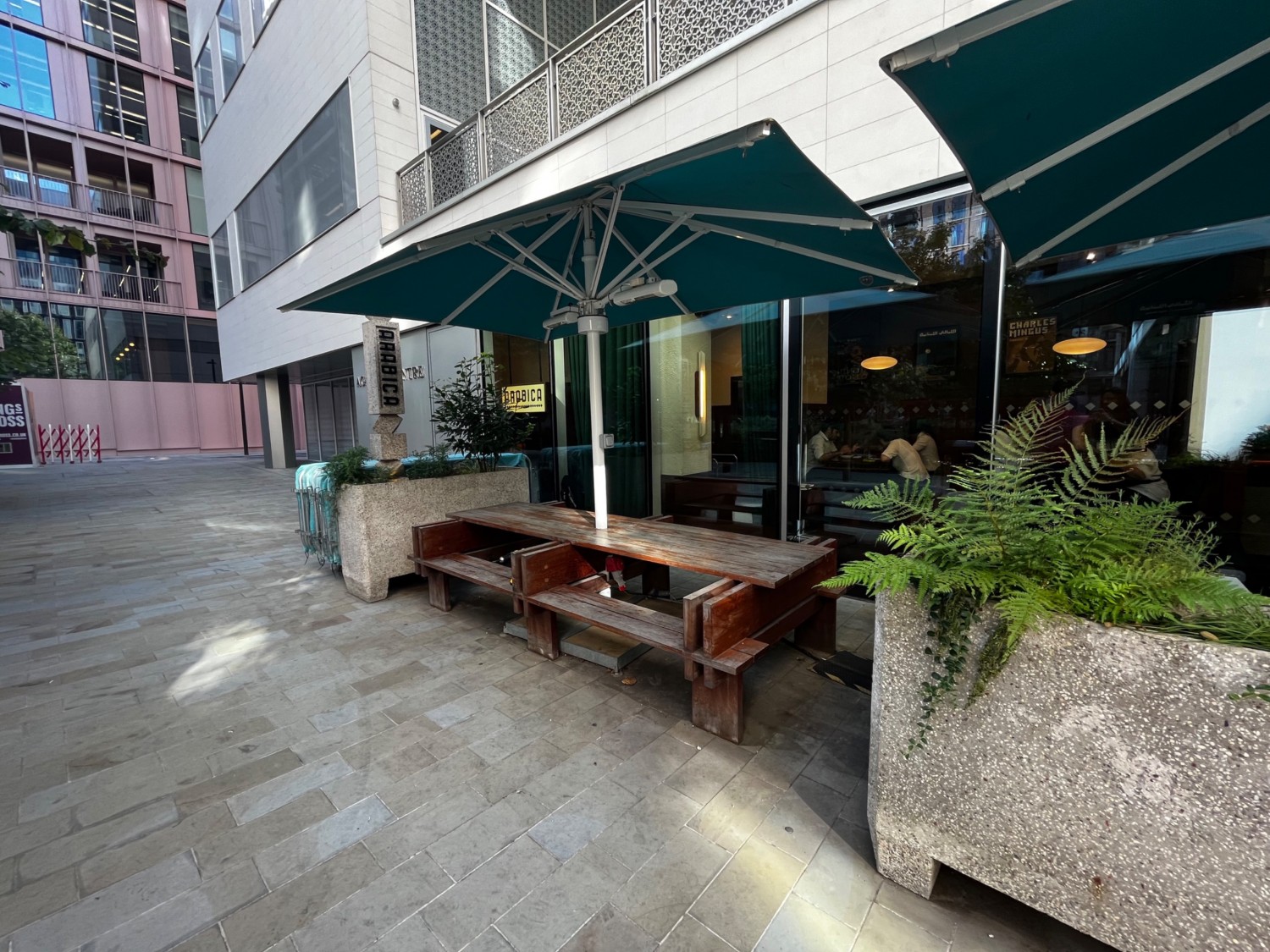 Continuation of outdoor area on left of venue. Integrated table with benches on outer wall.