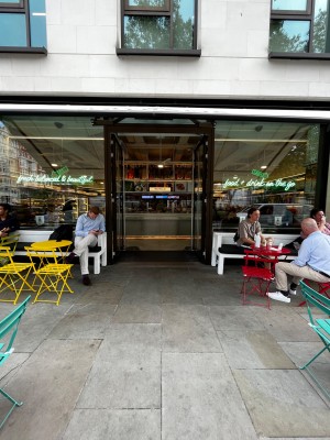 Large glass doors with black frame. Push silver metal handles in middle to open.
