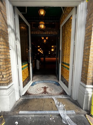 Glass doors with white frame ahead. Push doors to open from center.