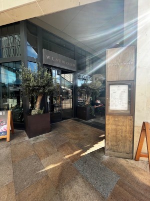 Path to entrance doors. Doors ahead on left past initial signage on right.