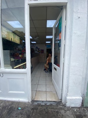 Glass door with white frames. Push from left to open.