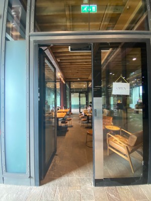 Double doors with black door frames. Push open from middle.