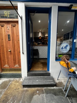 Single glass door in blue wooden frame. Push silver metal handle from right to open.
