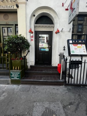 3 steps up to door. Handrail on left. Pull glass door with green frame from right to open.