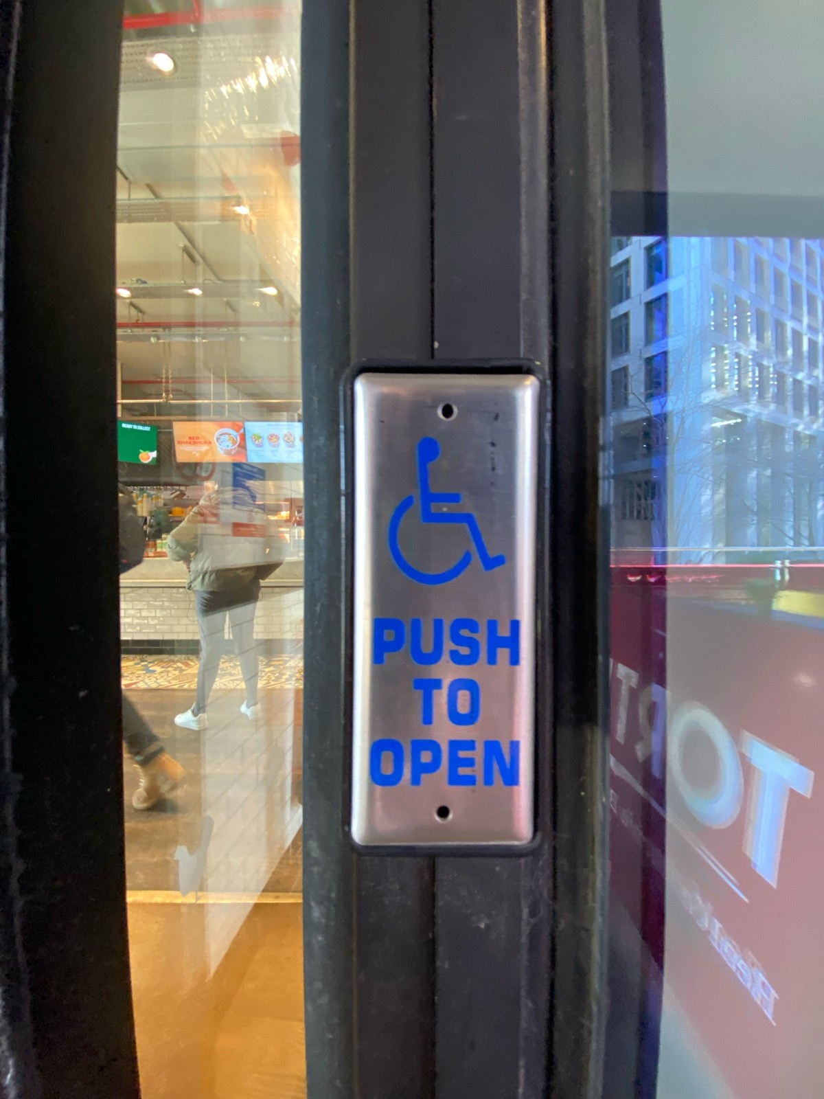 Push button to right of doorway.