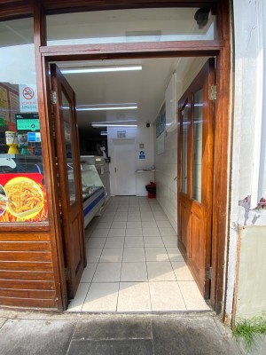 Double wooden doors with glass panels. Push sliver handles in middle to open.