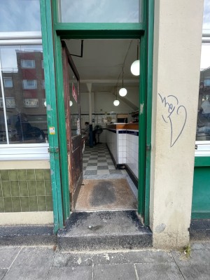 Single door with glass panel. Push brass handles on left to open.