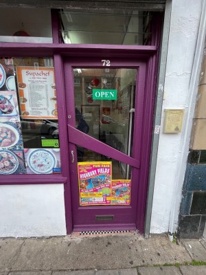Push purple and glass door with handle on the left.