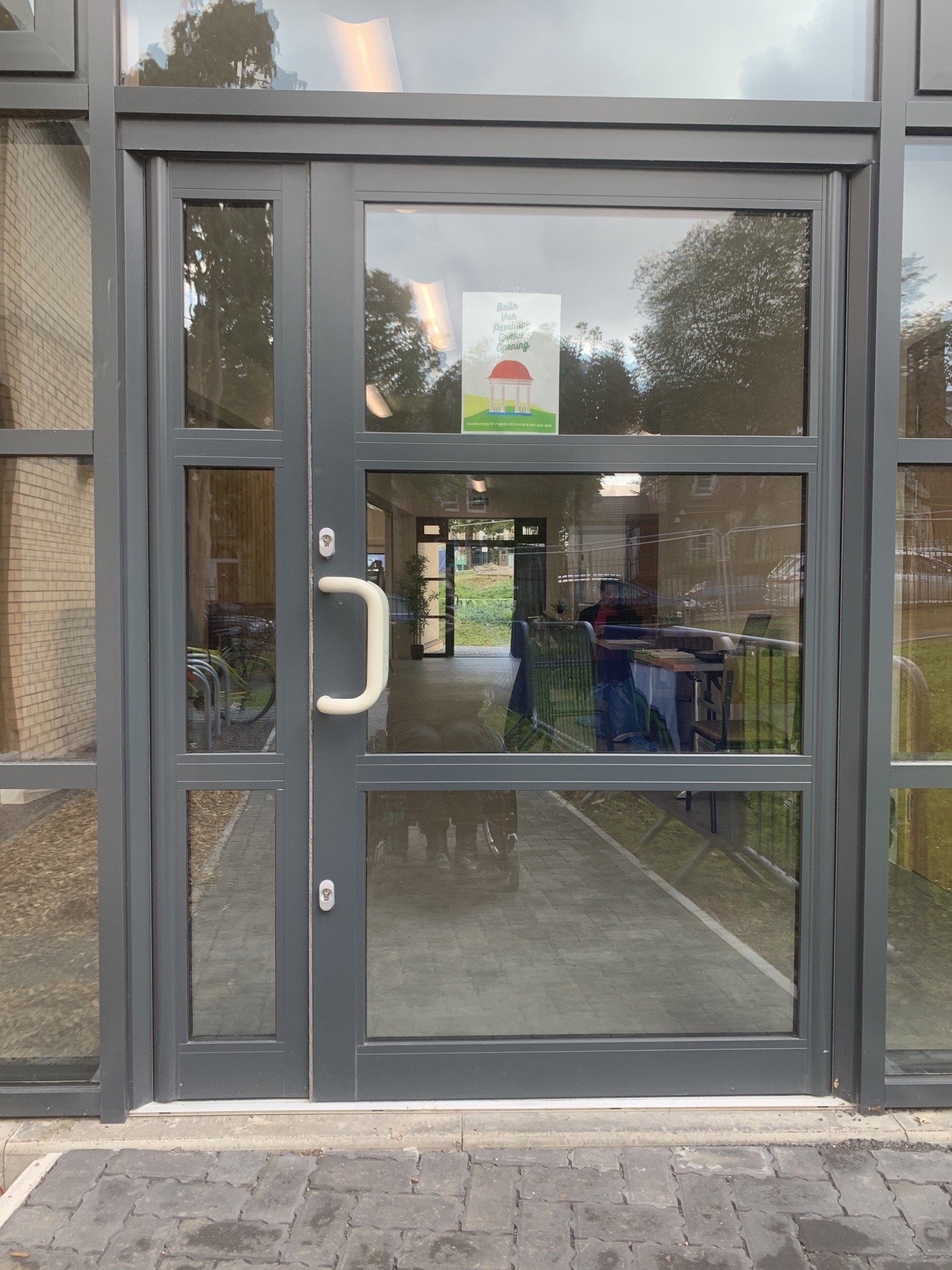 Glass and metal door, colour contrasted handle, opens outwards, small bump to get in.