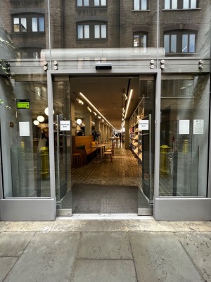 Glass automatic sliding doors open from middle.
