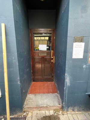 Pull wooden door with handle on the right.