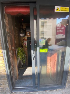 Preceding Sliding glass door with a handle on the left.
