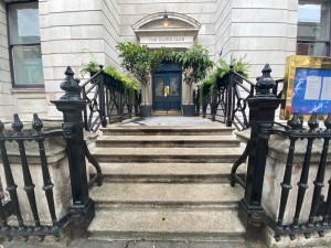 View from street. Steps with handrail on both sides leading to preceding doors to main area.
