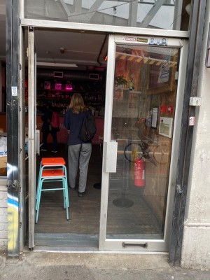 Grey-framed double glass push doors. Handles in middle. Small bump along door.