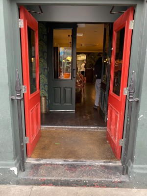 Red doors with glass panels ahead. Push doors from center to open.