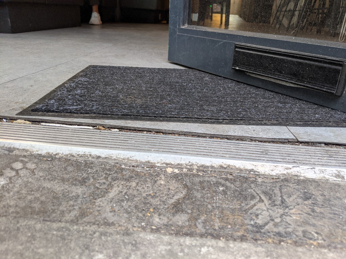 Small bump at foot of door, followed by doormat.