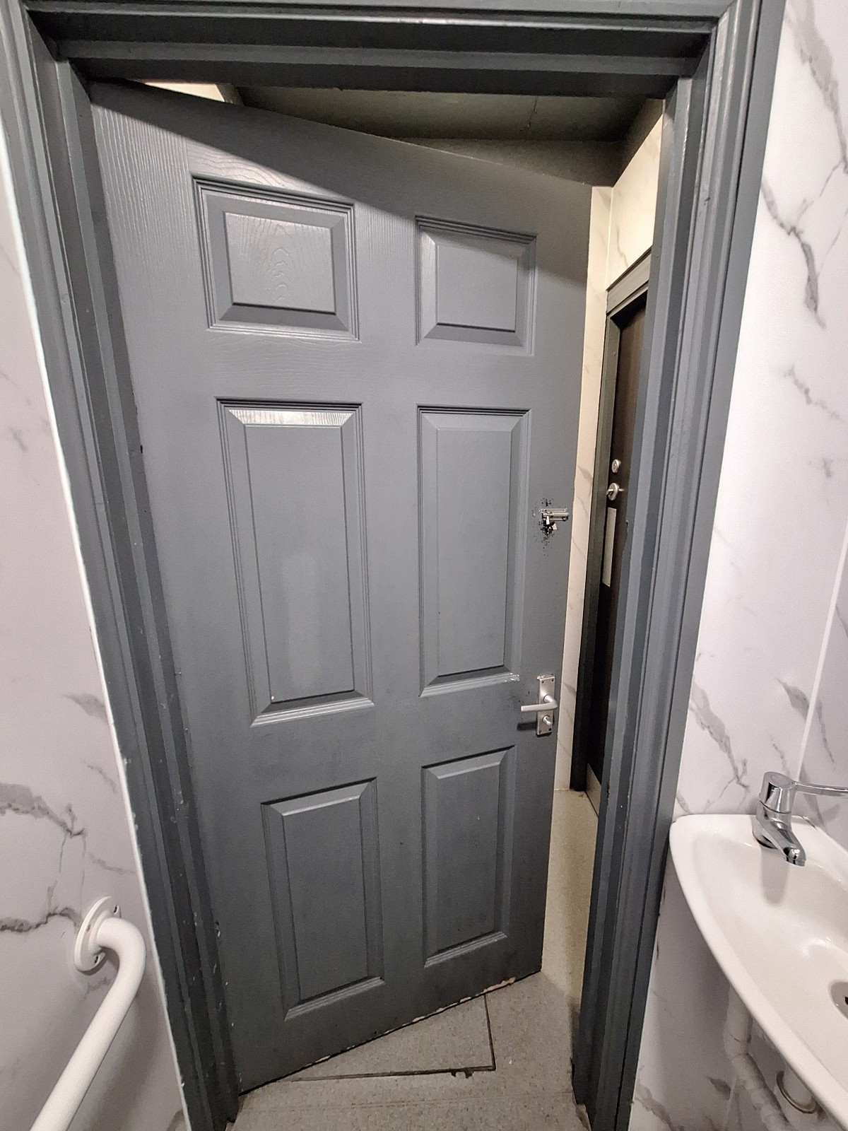 Back of grey door. Push handle on right to open.