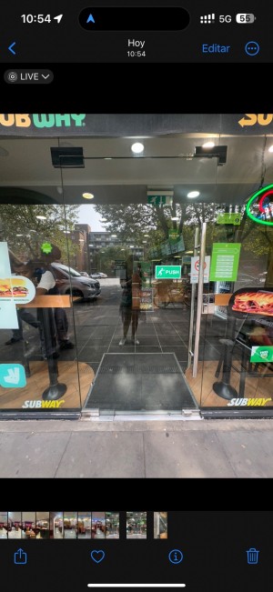 Single glass door with handle on the right. Push to open.