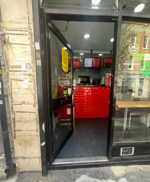 Single glass door with handle on the right. Push to open. 1 step before entering.