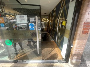 Double glass doors to be pushed from centre to open. Step before door.