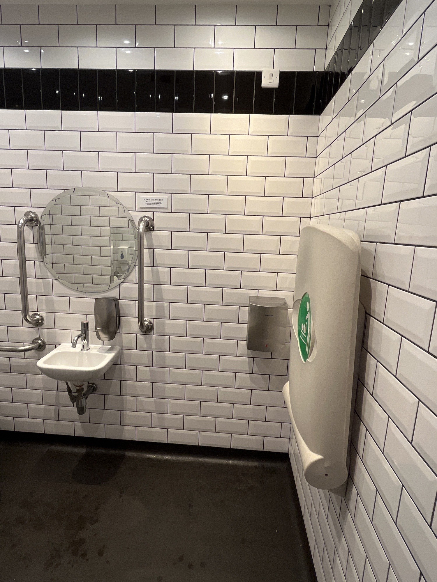 From bathroom door facing straight. Baby change table on right wall. Sink ahead on back wall.