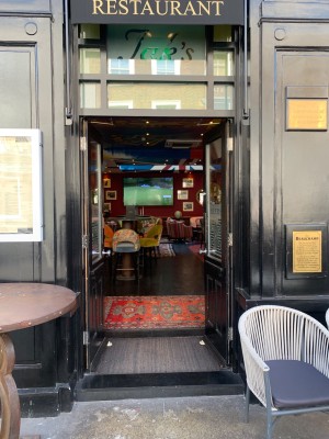 Double doors from the street, with outdoor seating to left & right, push door from centre to open.